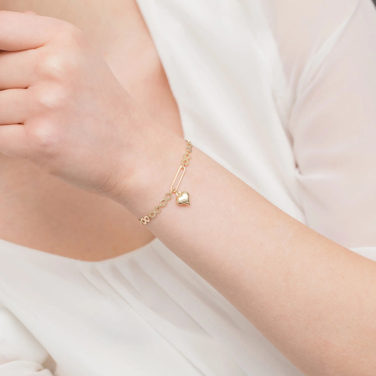 14k Gold bracelet with infinity symbols and a heart charm. Packaged in elegant black box and a gift bag.